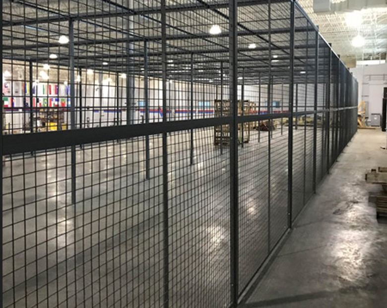 Weldmesh partition forming a secured cage inside a warehouse
