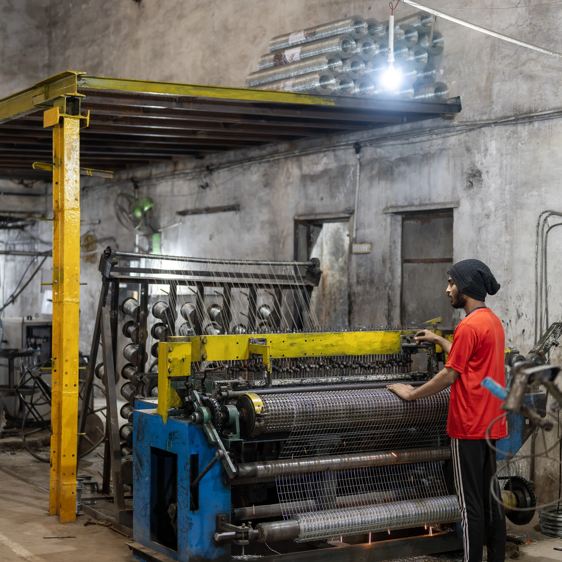 Quality inspector measuring mesh opening on a finished weldmesh panel